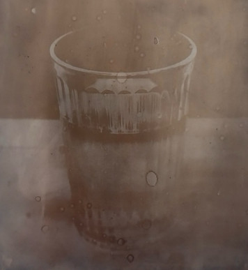 AI generated: The image shows a half-full glass of water standing on a flat surface. The image has a sepia-coloured, slightly blurred effect, which gives the picture a nostalgic atmosphere.